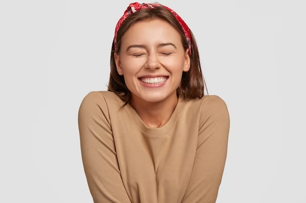 portrait-happy-european-woman-has-broad-smile-closes-eyes-feels-excitement-being-high-spirit_273609-_1