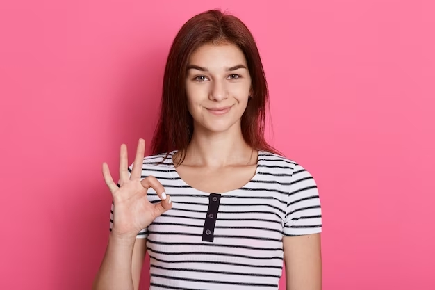 portrait-happy-young-brunette-girl-showing-ok-gesture-with-fingers-with-charming-smile-has-excellent